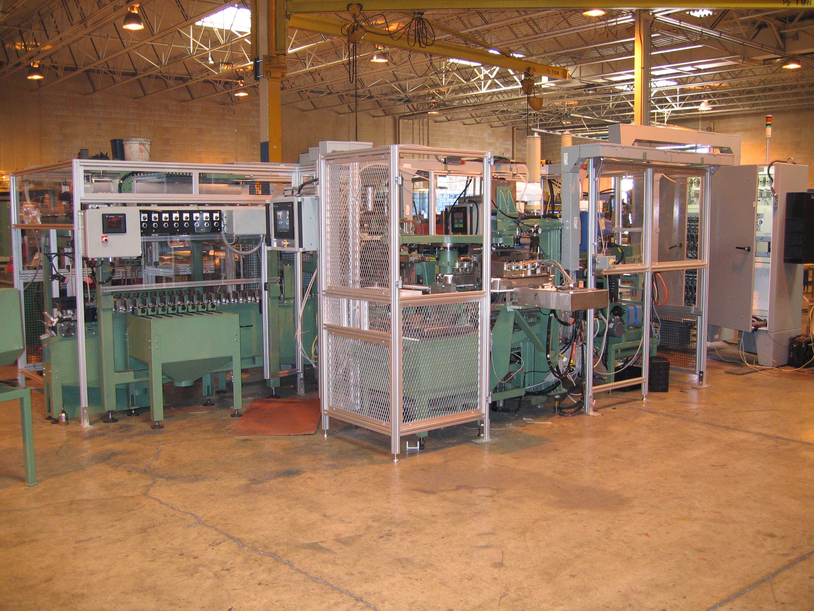 An industrial assembly line with machinery and conveyor belts inside a factory.
