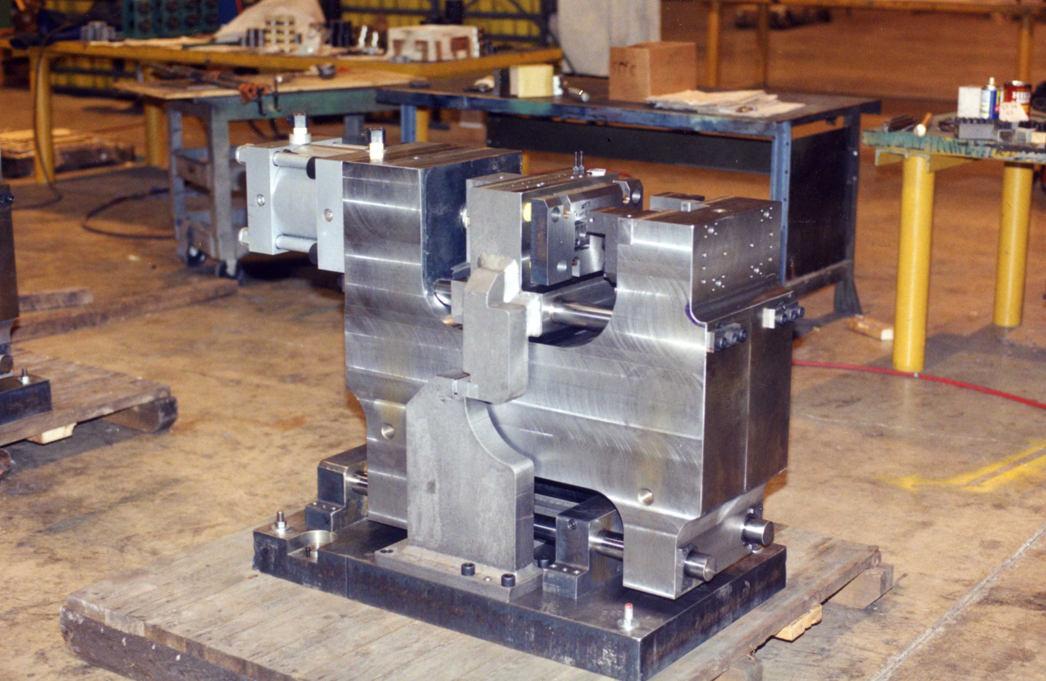 A large metal industrial machine part on a workshop floor.