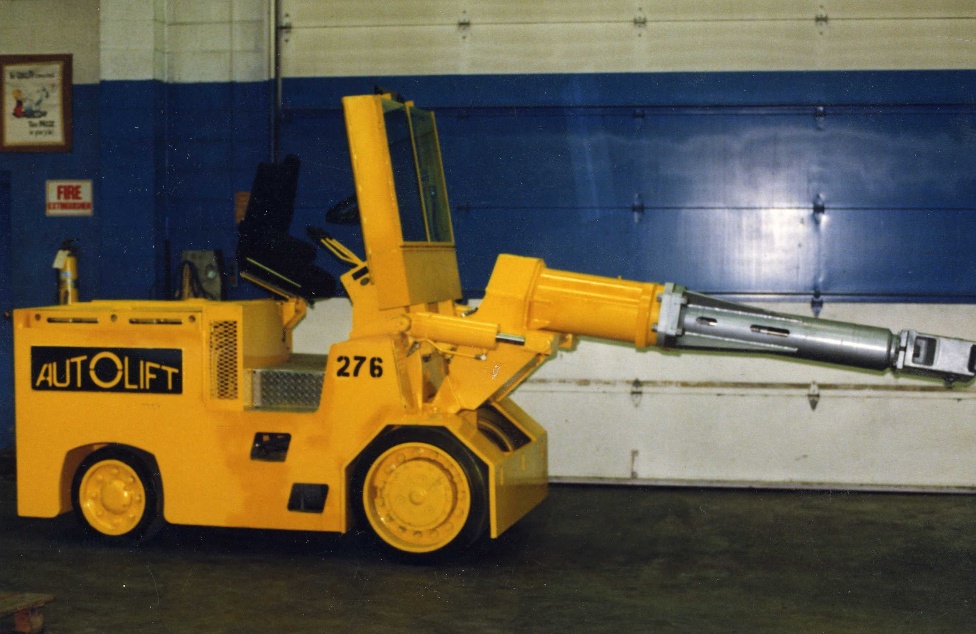 A yellow industrial forklift inside a warehouse.